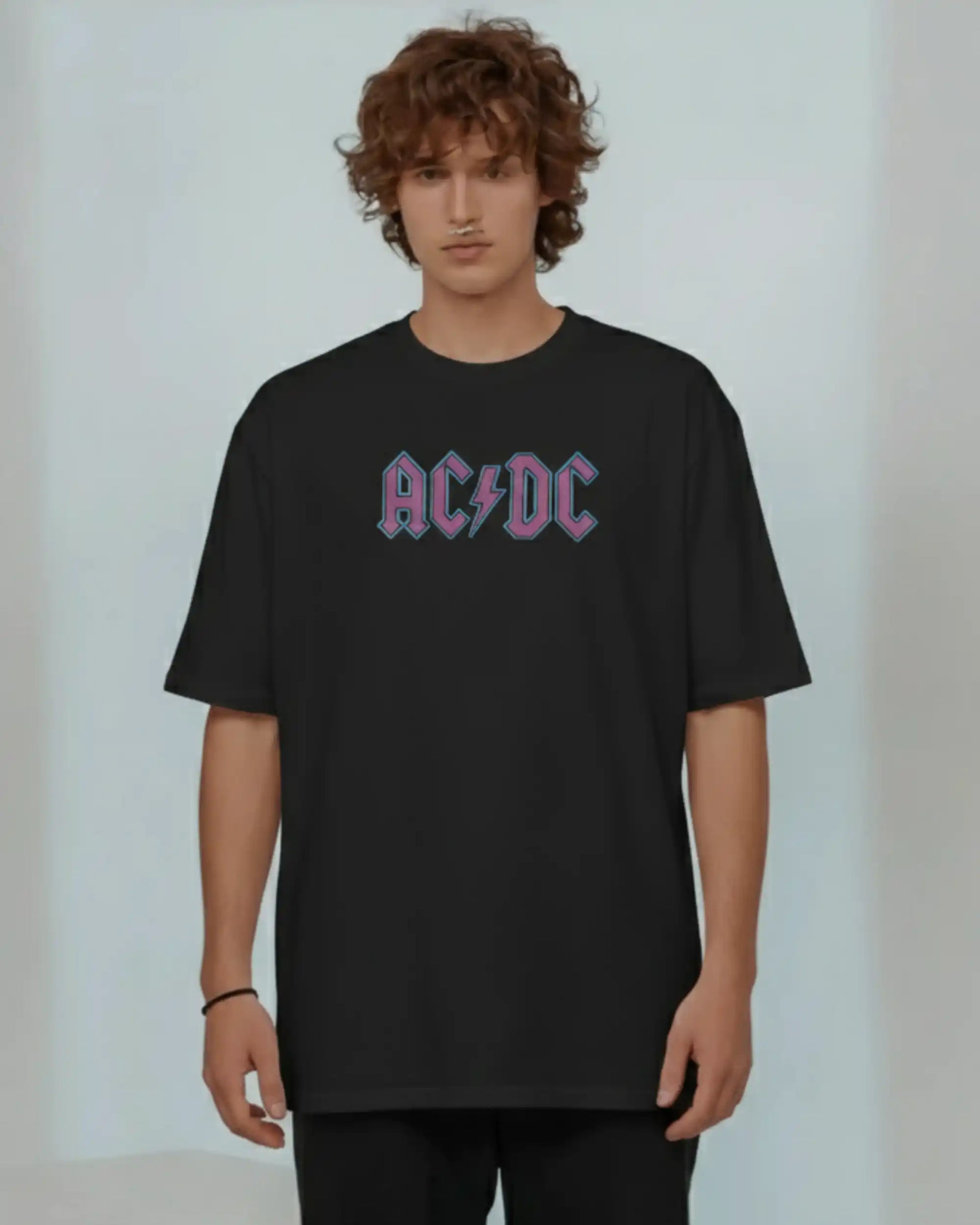Black plus size oversized t-shirt with AC/DC logo graphic design on front, modeled against a plain background