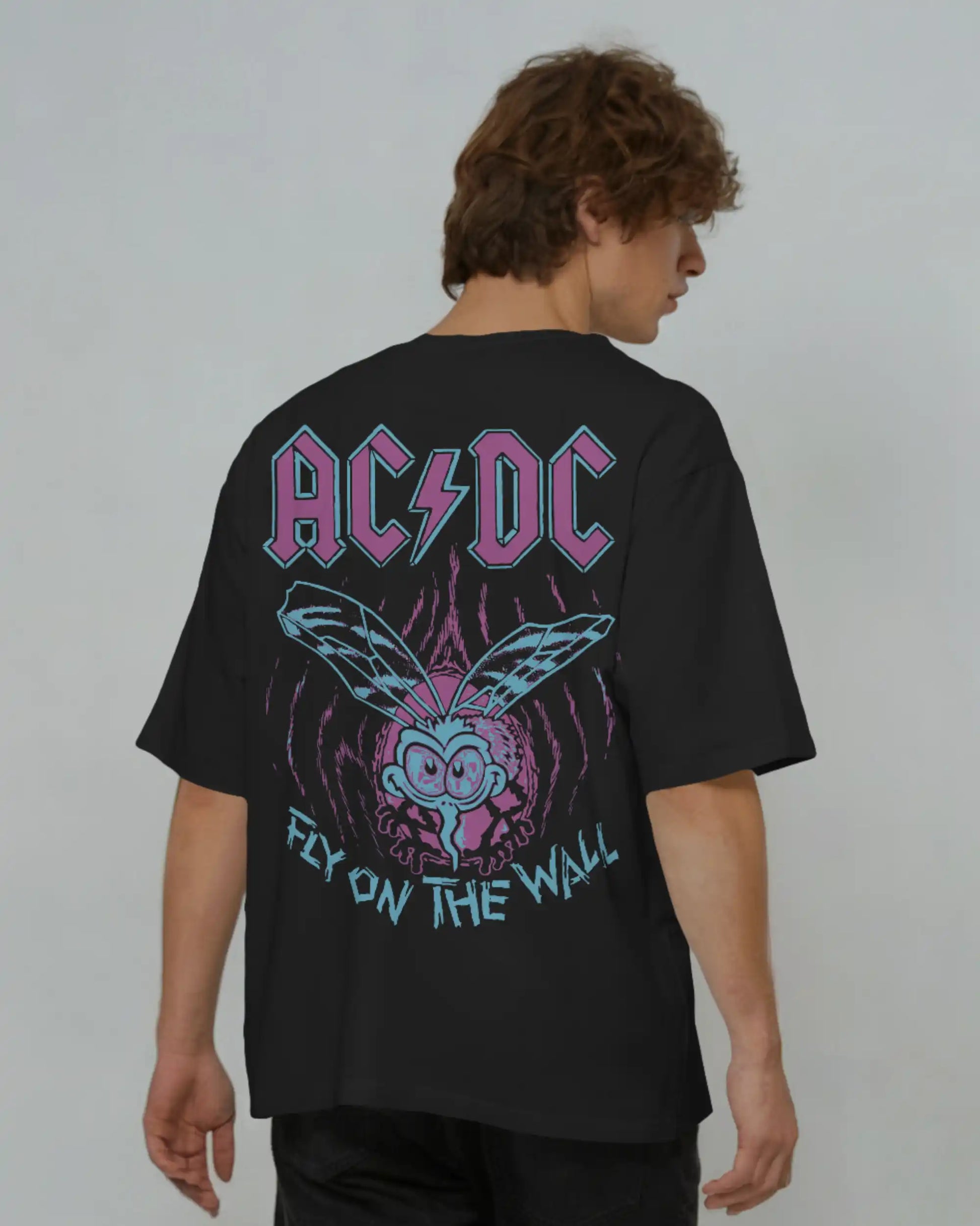 Black plus size oversized t-shirt with AC/DC Fly on the Wall graphic design on back, modeled against a plain background