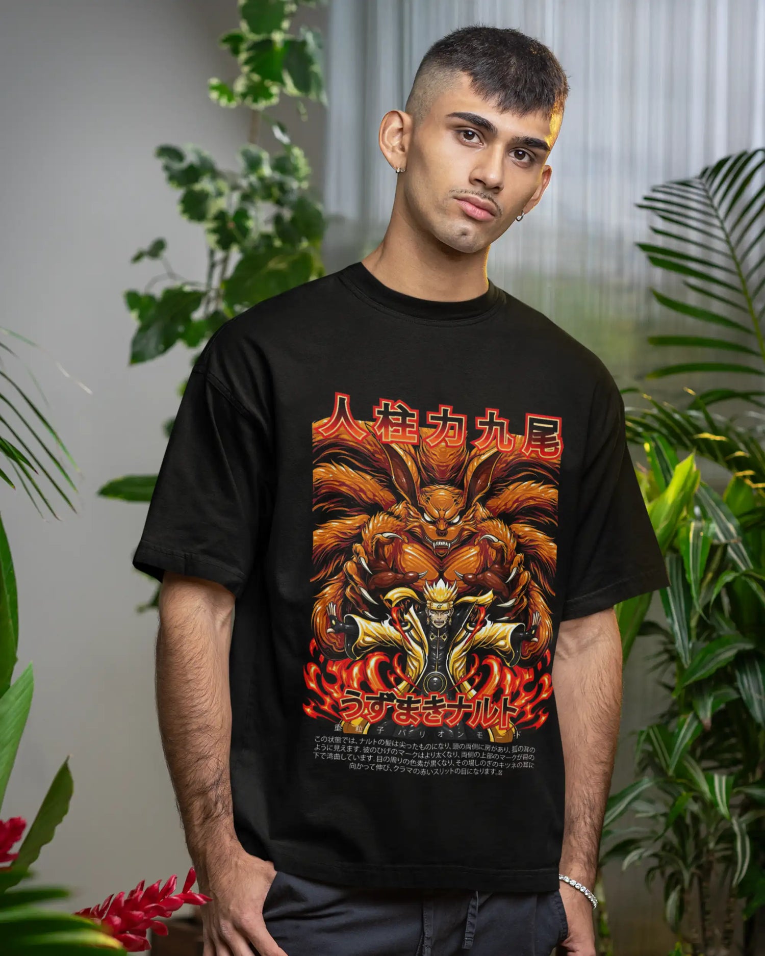 Black plus size dragon warrior beast mode anime t-shirt with fiery nine-tailed graphic print, premium cotton oversized fit for men, model indoors with plants, AWBlack Store
