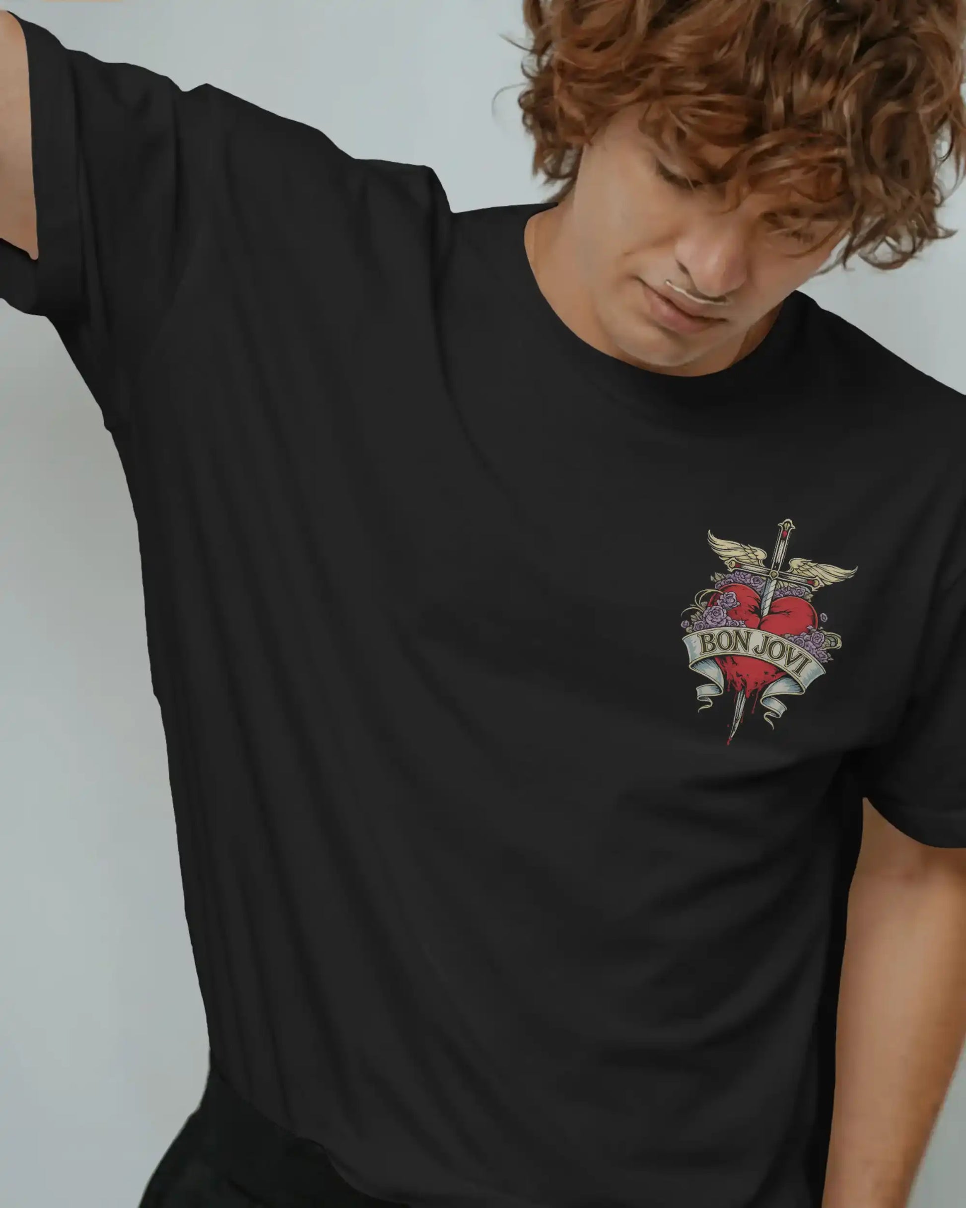 Black plus size oversized t-shirt with Bon Jovi graphic logo on chest, modeled in a relaxed pose