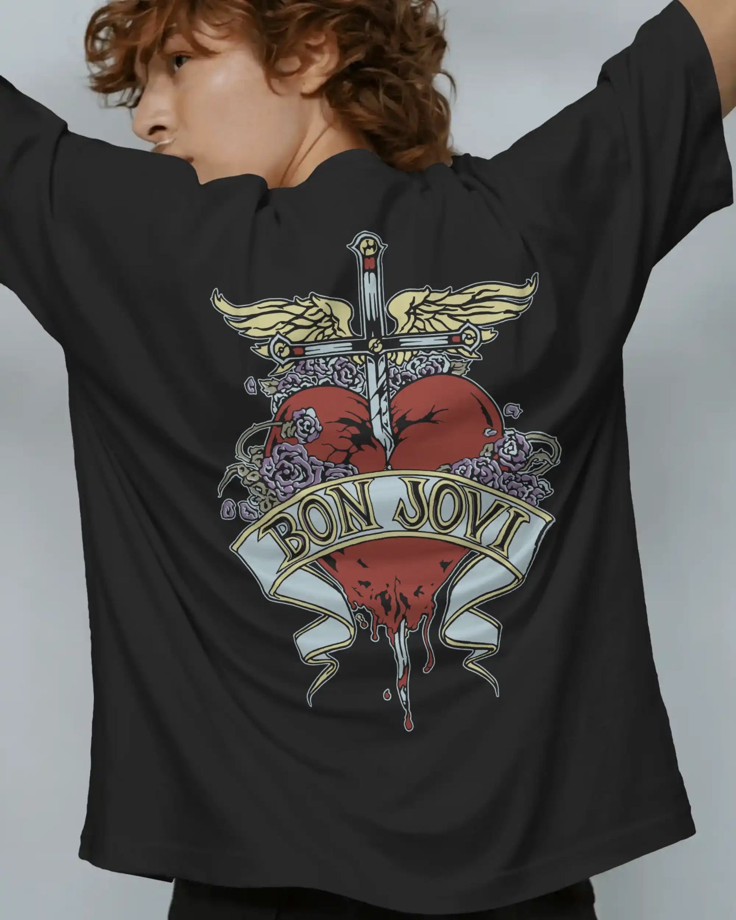 Black plus size oversized t-shirt with Bon Jovi iconic graphic design on the back, modeled by an individual