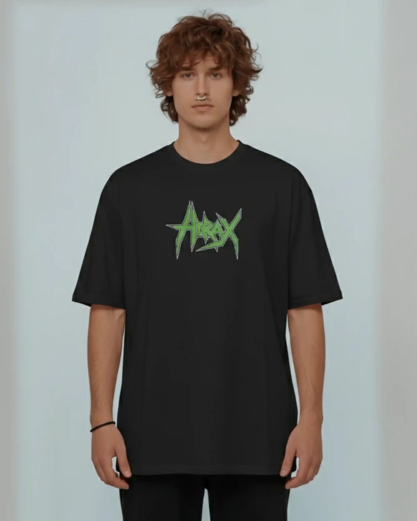 Man wearing black heavyweight plus size t-shirt with Hirax green logo, lifestyle front view for comfortable fit.