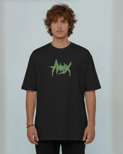 Man wearing black heavyweight plus size t-shirt with Hirax green logo, lifestyle front view for comfortable fit.