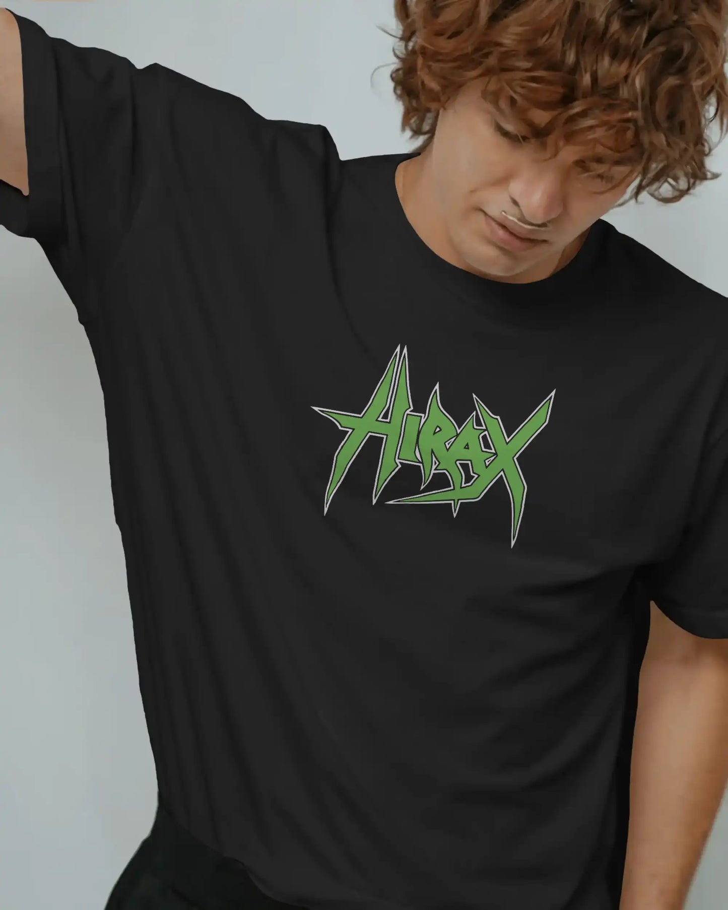 Close-up of man wearing black plus size t-shirt with green Hirax logo, heavyweight 240GSM fabric detail and relaxed fit.